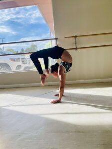 acrobatic intermediate dancer working on her handstand variations in dance class at LA Dance Academy