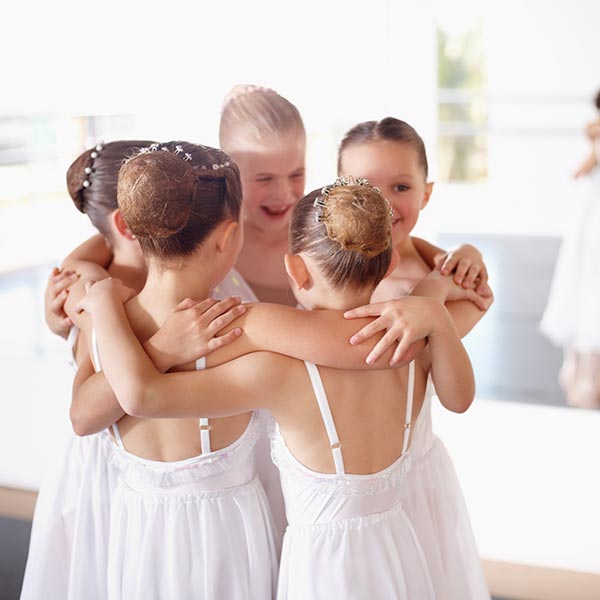young lyrical dancers hugging after class at LA Dance Academy