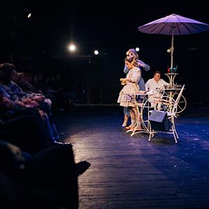 students-on-stage-performance-musical-theatre teenagers on stage performing a musical in front of an audience.