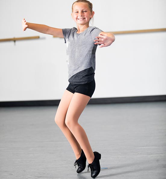 young dancer working on her toe stand in tap dance