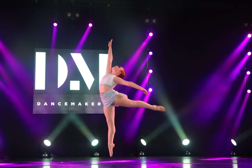 a young dancer on stage for her solo competition in lyrical