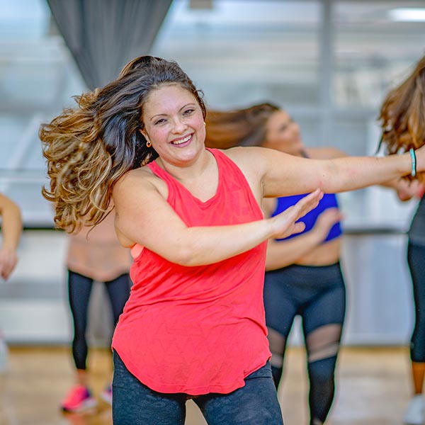 adult women in dance fitness class smiling with her friends at LA Dance Academy