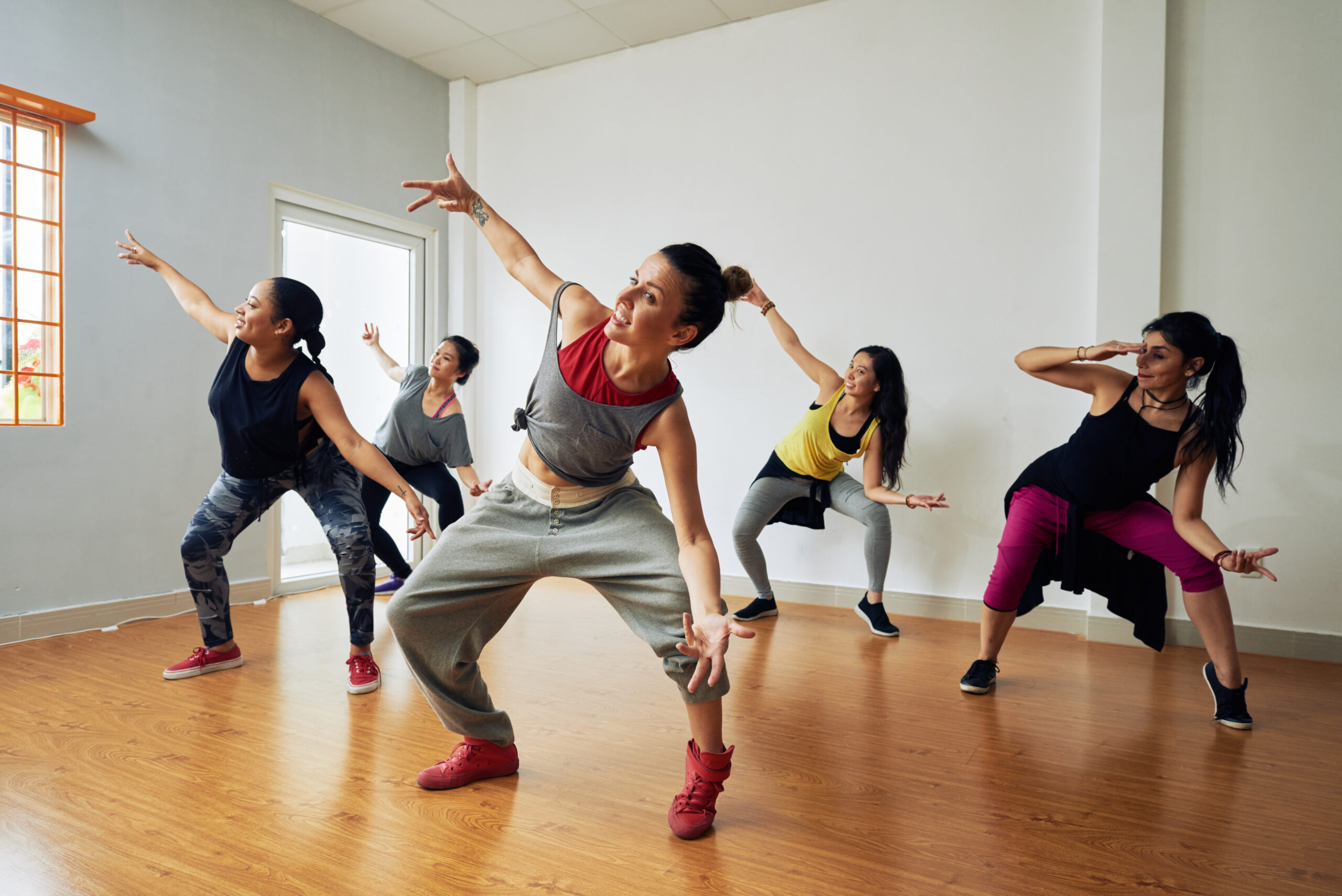 adults in their jazz funk class having fun with other adults