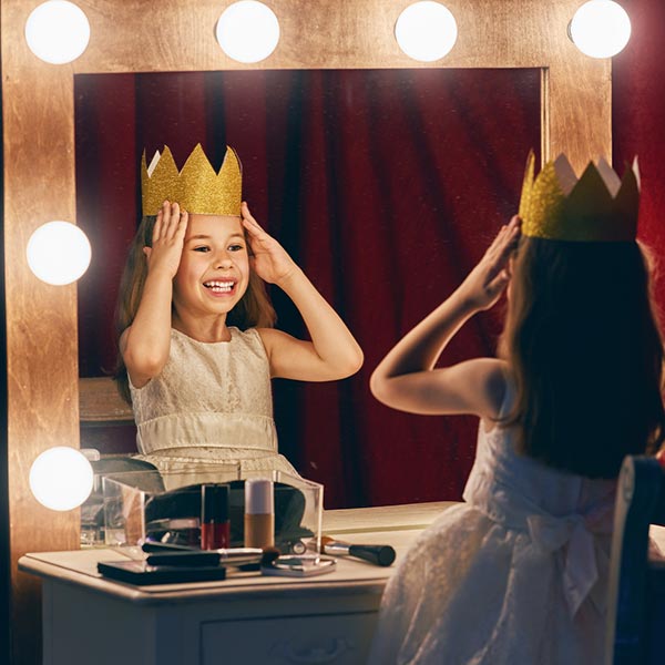 young dancer getting ready for the musical play wearing a princess crown