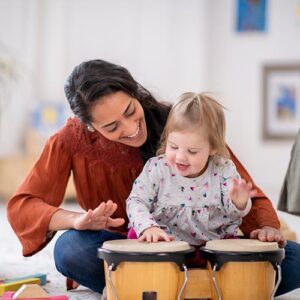 mom and baby playing drums together during a bonding class at LA Dance Academy