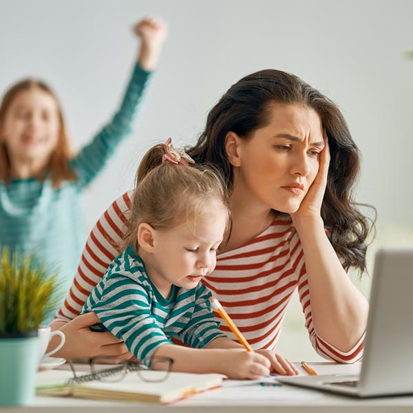 mom at home trying to work with kids playing