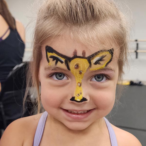 young girl with giraffe face paint during safari camp at LA Dance