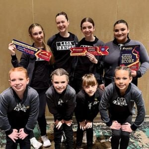 team photo holding their awards after a dance competition