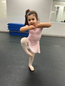 young dancer working on her passa during ballet class