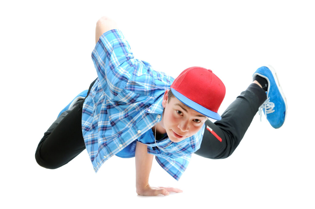 Intermediate male hip hop dancer doing a freeze during his hip hop class taught by a male teacher