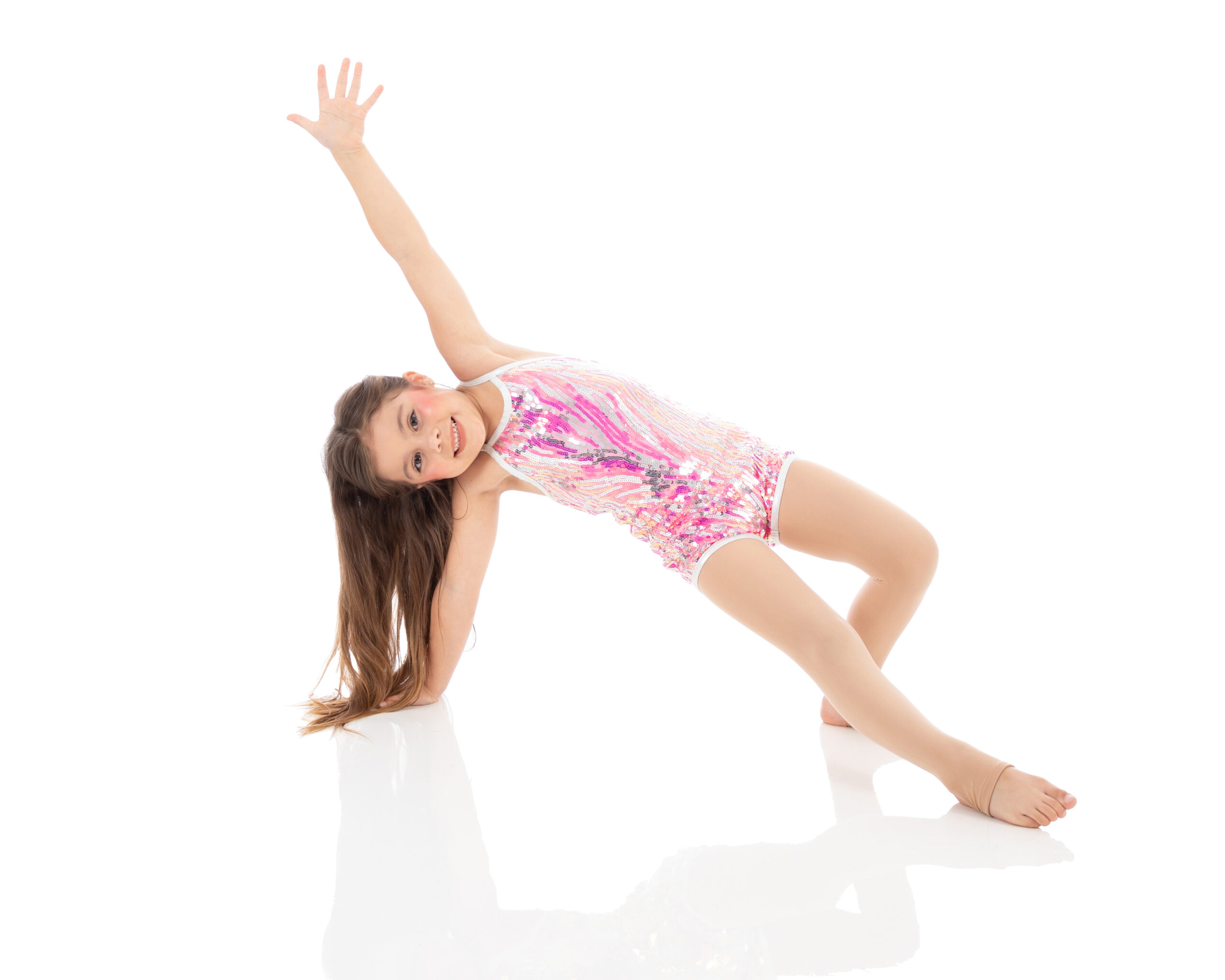 Tumbling I - arch on hand Beginner level tumbling student working on her core strength and her balance with a smile at LA Dance Academy.