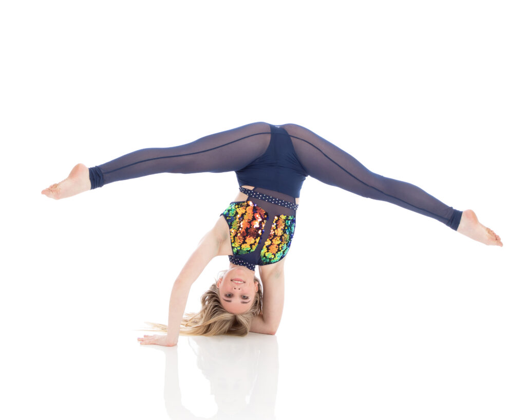 Arco Advanced elbow stand with split Advanced acro student in an elbow stand showing off her strength and flexibility.