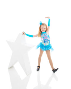 Young tap dancer in a combo dance class is showing off her tap knowledge during her photoshoot for the dance recital at LA Dance.