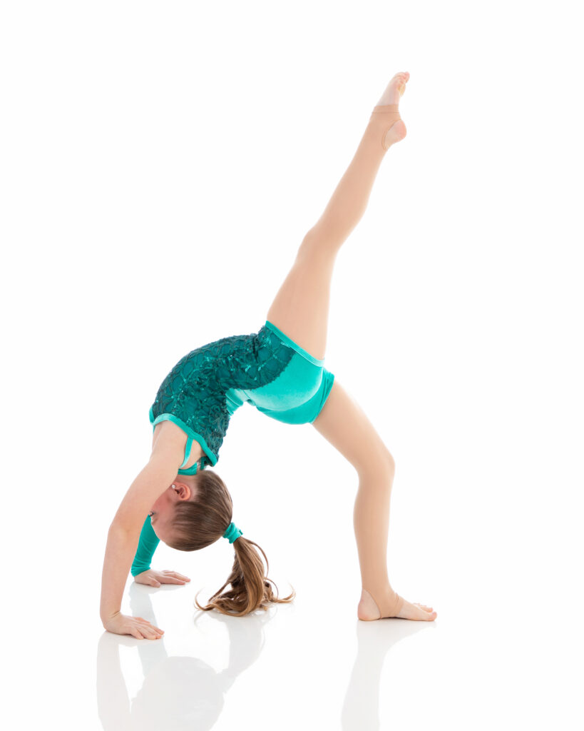 Tumbling I Intermediate Tumbling I student doing a backbend leg extension. Beginner level working on placement, strength and control.