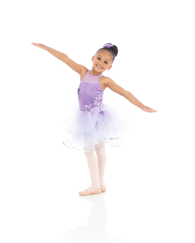 Tiny dancer II preschool ballet dancer showing her 5th arabesque in her costume for the LA Dance photoshoot before the recital.