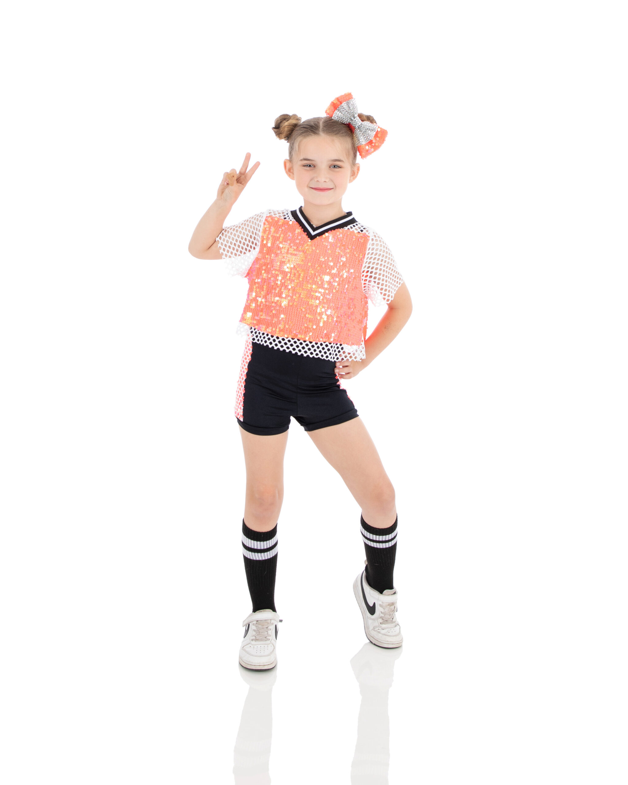 Hip Hop I - peace young hip hop dancer is all smiles and sass during her recital dance at LA Dance Academy.