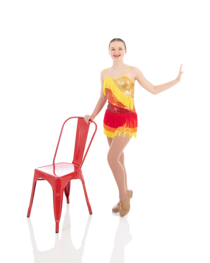 Tap III dig step with chair pose Advanced Tap dancer doing a toe pose with a chair for her photoshoot at LA Dance Academy.